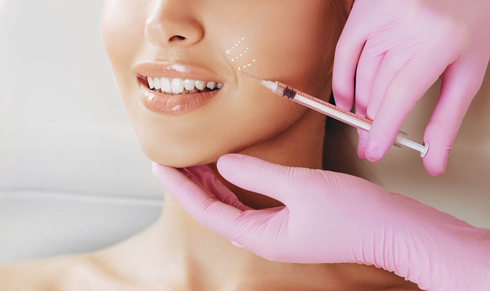 Cropped beautiful woman face gets a beauty injection. Lifting arrows show the removal of facial wrinkles